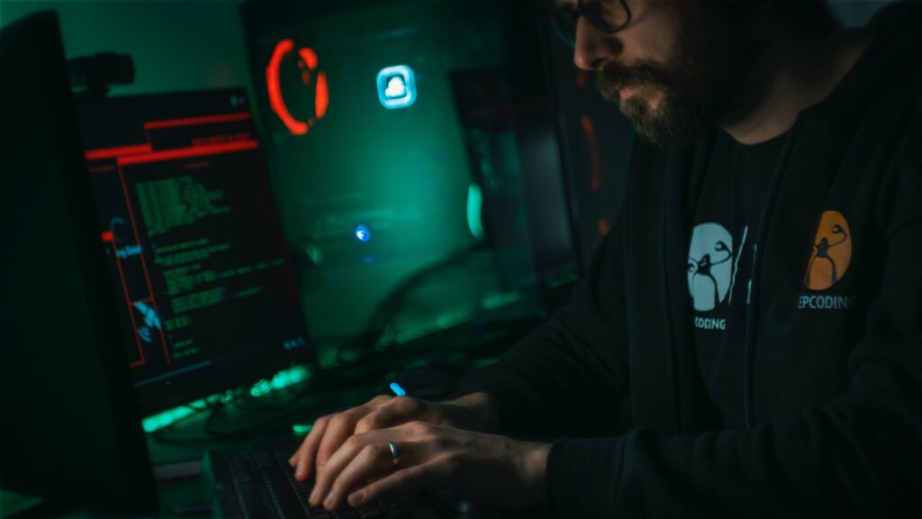 A man sitting in the dark coding